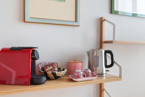 a shelf with a coffee maker and a toaster on it at Bed & Breakfast San Calocero - private bathroom - Wi-Fi in Milan
