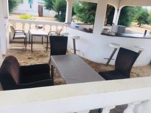 a patio with chairs and a table and a counter at Santana Beachclub in Sanyang