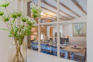 a dining room with a table and blue chairs at Merchant House in Charlbury