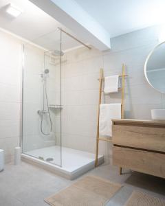 a bathroom with a shower with a glass door at A brand new, beautifully decorated maisonette. in Chalkida
