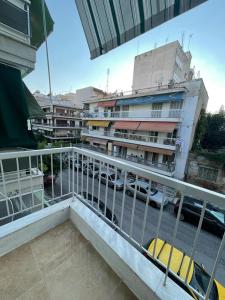a balcony with a view of a parking lot with buildings at Le Plaza in Thessaloniki