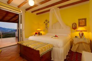 a bedroom with a bed and a balcony at Casa Nostra, stunning, elegant villa in Lipari with pool in Lipari