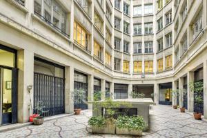 a large building with a table in the courtyard at Central & Stylish renovated Parisian apt / 6-8 guests in Paris