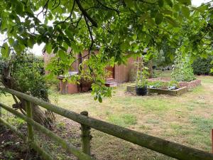 a wooden fence in a yard with some plants at Orchard Cabin Herefordshire Wye Valley in Ross on Wye