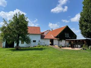 a large white house with a red roof at Statek Keblice in Keblice