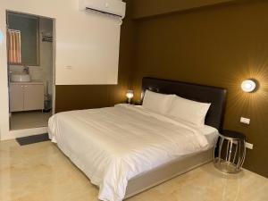 Een bed of bedden in een kamer bij 自在緣精品民宿