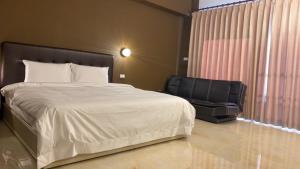 Een bed of bedden in een kamer bij 自在緣精品民宿