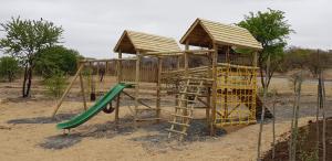 a playground with a slide and a play structure at The Springbok Lodge in Nambiti Private Game Reserve