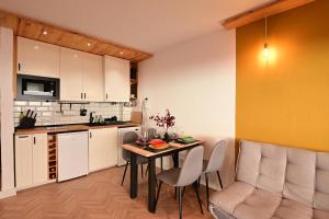 a kitchen and dining room with a table and chairs at The view will convince you! in Puerto de Santiago