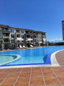 a large swimming pool in front of some buildings at Villa Ina & Eva Bayview Deluxe in Burgas City