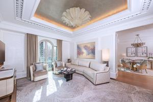 a living room filled with furniture and a large window at Emirates Palace, Abu Dhabi in Abu Dhabi