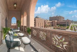 a large stone building with a balcony overlooking a river at Emirates Palace, Abu Dhabi in Abu Dhabi