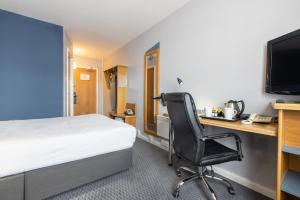 a bedroom with a bed, desk, chair and television at Holiday Inn Express Aberdeen City Centre, an IHG Hotel in Aberdeen