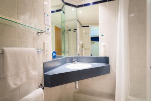 a bathroom with a tub, sink and mirror at Holiday Inn Express Aberdeen City Centre, an IHG Hotel in Aberdeen