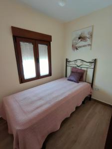 a bedroom with a bed in a room with two windows at Casa Valentín in Casillas