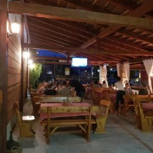 a group of people sitting at tables in a restaurant at H&S Mobile Home in Privlaka