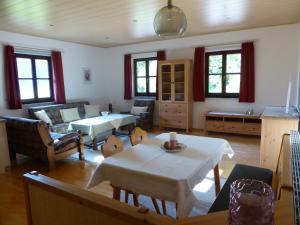 a living room with a table and a couch at Haus Hütter in Altaussee