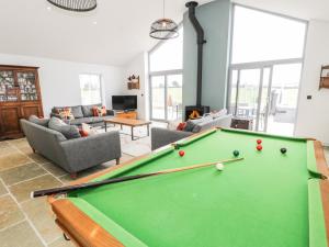 a living room with a pool table at Cae Sam in Pentraeth