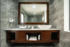 a bathroom with a sink and a mirror at DAD Resort Phú Quốc in Phú Quốc