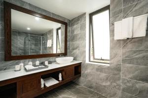 a bathroom with a sink and a mirror at DAD Resort Phú Quốc in Phú Quốc