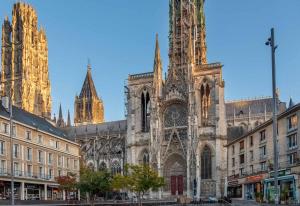 a large cathedral with two towers in the background at Hôtel Littéraire Gustave Flaubert, BW Signature Collection in Rouen