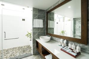 a bathroom with a sink and a mirror at DAD Resort Phú Quốc in Phú Quốc
