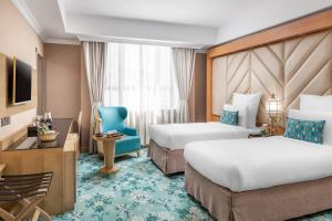 Säng eller sängar i ett rum på Elaf Al Taqwa Hotel