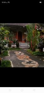a walkway leading to a home with a house at Dewi Antara Homestay in Ubud