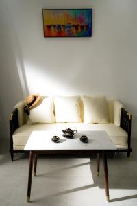 a white couch with a coffee table in a living room at DAD Resort Phú Quốc in Phú Quốc