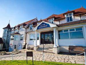 a hotel with a sign in front of a building at North Shore Hotel in Skegness