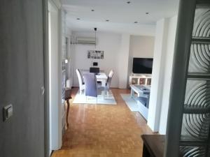 a dining room and living room with a table and chairs at HomeB&E in Tuzla +5 photos