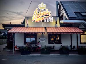 a restaurant with people sitting at a table outside at Aleksandri Guesthouse in Pärnu