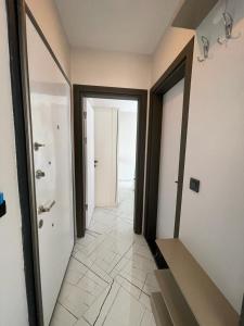 a hallway with two doors and a tile floor at LOTUS Apart in Kusadası