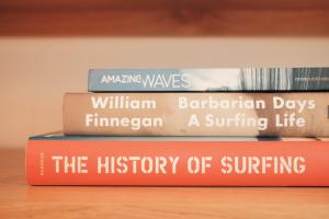 four books stacked on top of each other on a shelf at Surf Shanty Motel in Dewey Beach
