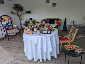 a table with a white table cloth on it at La Lézardière in Paradou