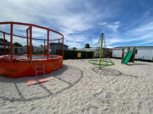 two playground equipment in the sand on a beach at Bienvenue chez Anaïs ! in Biville-sur-Mer
