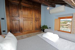 a living room with a couch and a wooden door at Augusto Imperial Apartment and Suites - Castel Sant'Angelo in Rome