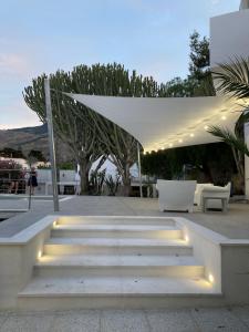a set of stairs with lights under a white canopy at Residence Tamarea in Valderice