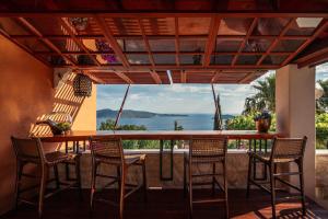 a bar with chairs and a view of the ocean at NINON Dubrovnik - Adults Only in Brsečine