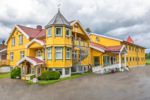 a large yellow building with a tower on top at Gardermoen Hotel Bed & Breakfast in Gardermoen