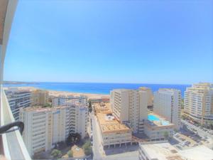 a view of the beach from the balcony of a building at Tarik Beach Apartment in Portimão