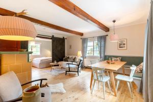 a living room with a table and a dining room at Cottage Hohe Tauern in Mallnitz