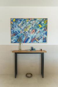 a painting hanging on a wall with a table at Villa Bellevue Vodice in Vodice