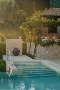 a swimming pool with a stairway leading to a house at NINON Dubrovnik - Adults Only in Brsečine