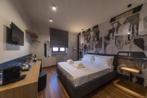 a bedroom with a bed and a desk in it at Villa Pietra Bianca - Luxury stay in Puglia in Trani +38 photos