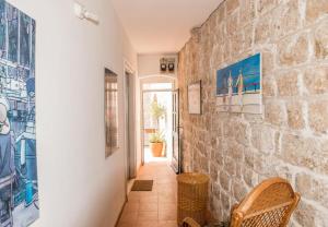 a hallway of a house with a stone wall at Apartment & Room Dubrovnik Sweet Home in Dubrovnik
