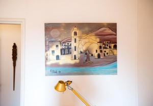 a painting hanging on a wall next to a lamp at Apartment & Room Dubrovnik Sweet Home in Dubrovnik