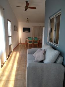 a living room with a couch and a table at CASA MUY COMODA A METROS DEL SANTUARIO Y ECOPARQUE in San Nicolás de los Arroyos