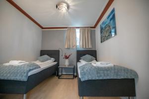 Un pat sau paturi într-o cameră la Gardermoen Hotel Bed & Breakfast