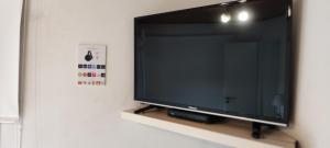 a flat screen tv sitting on a shelf at Canciller House Maipu in Maipú